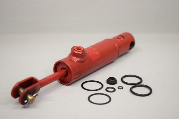 A red cylinder with many different rubber parts around it.