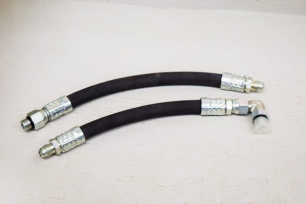 A pair of black hoses on a white surface, specifically the Rear Lift Cylinder Hoses D-Series Wheel Horse.