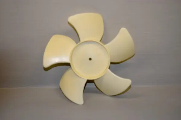 A yellow fan is sitting on the floor.