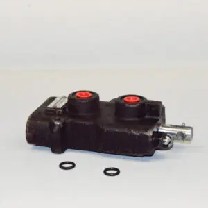 A black and red valve is sitting on the floor