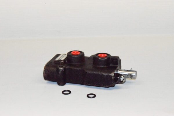 A black and red valve is sitting on the floor