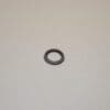 A black ring sitting on top of a white wall.