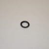 A black ring sitting on top of a white table.