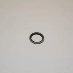 A black ring sitting on top of a white surface.