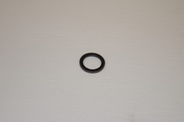 A black ring sitting on top of a white table.