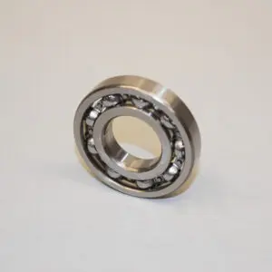 A ball bearing with a metal rim on top of a white surface.