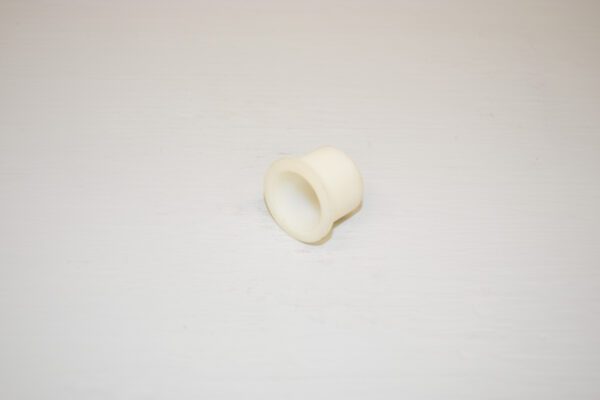 A white plastic Toro Wheel Horse Flanged Bearing on a white surface.