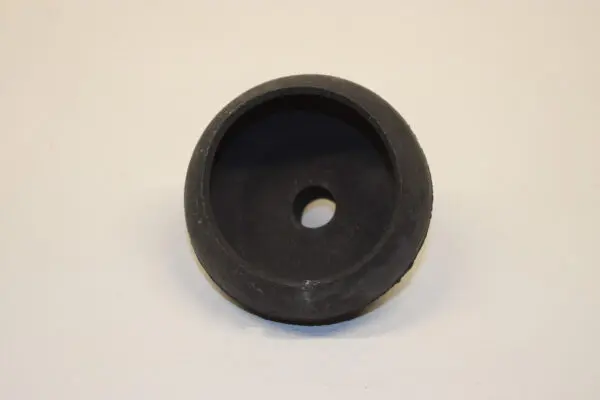 A black rubber washer sitting on top of a white table.