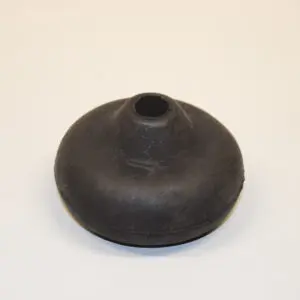 A black rubber object sitting on top of a white surface.