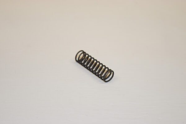 A small metal spring sitting on top of a table.