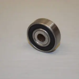 A ball bearing is sitting on the floor.