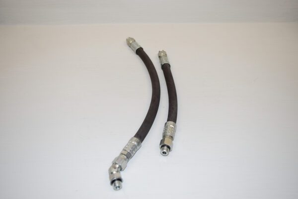 Two black hoses are connected to a pair of silver couplers.