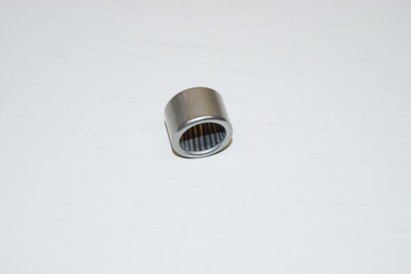 A metal bearing sitting on top of a white surface.