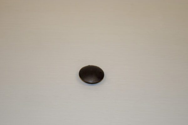A black bowl sitting on top of a white wall.