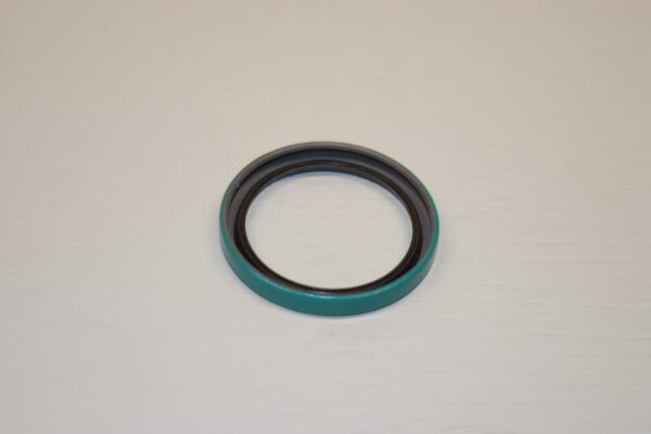 A green and black ring on top of a white table.
