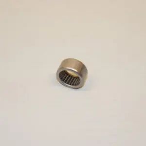 A metal bearing sitting on top of a white surface.