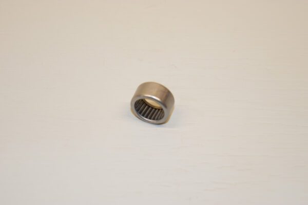 A metal bearing sitting on top of a white surface.