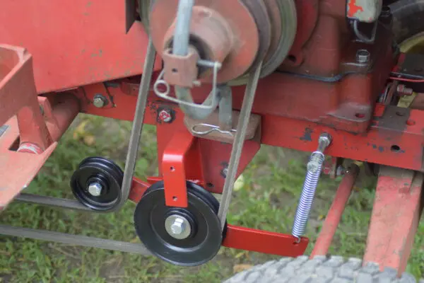 A close up of the wheels on a red machine