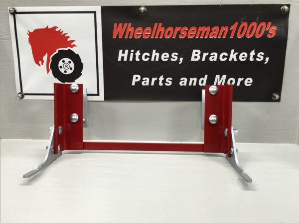 A red and silver metal stand with wheels on top of it.