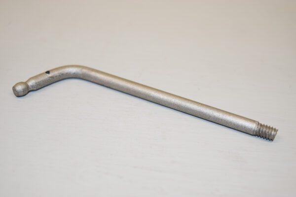 A metal bent handle on top of a table.