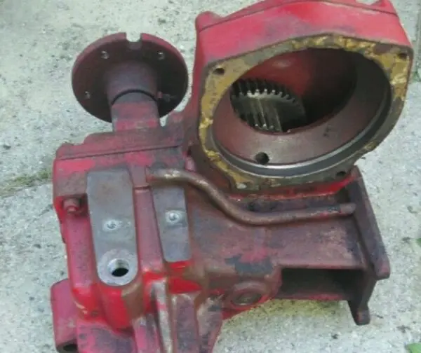 A red and black rusted gear box