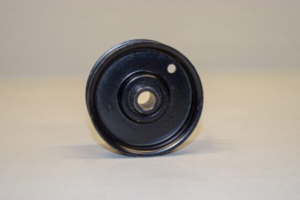 A Pulley for Wheel Horse on a white surface.