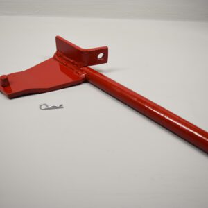 A red handle is laying on the ground.