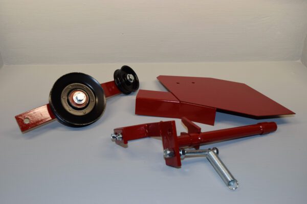 A red piece of metal with wheels and other parts.