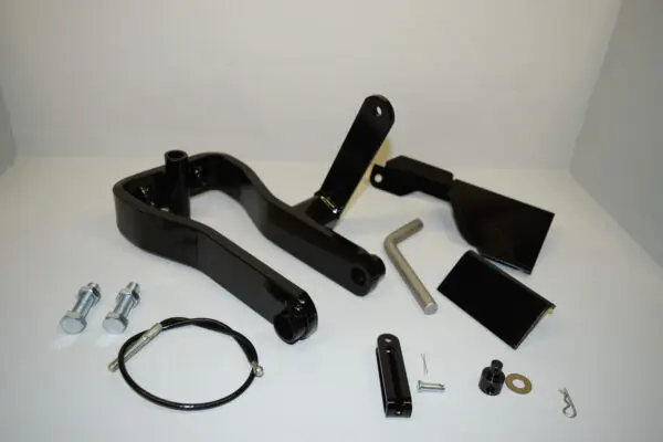 A black handle and some parts are laying on the table