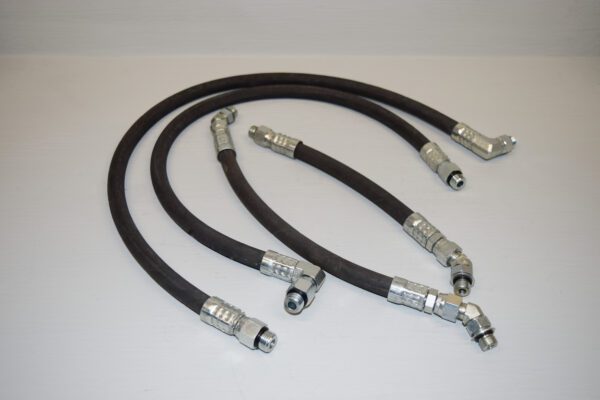 A set of four hoses with different types of couplings.