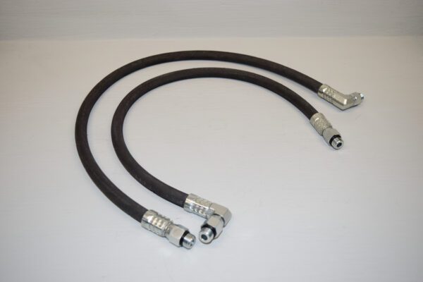 Two black rubber hoses with metal fittings on a white surface.