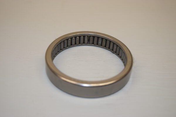 A metal bearing is sitting on top of the table.
