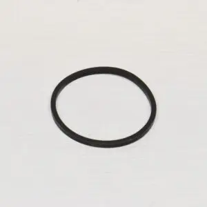 A black rubber ring is sitting on top of a white table.