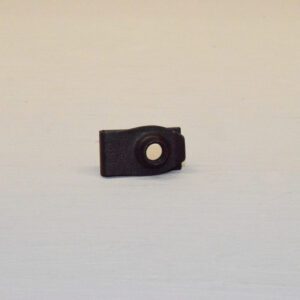A black plastic clip on the side of a white table.