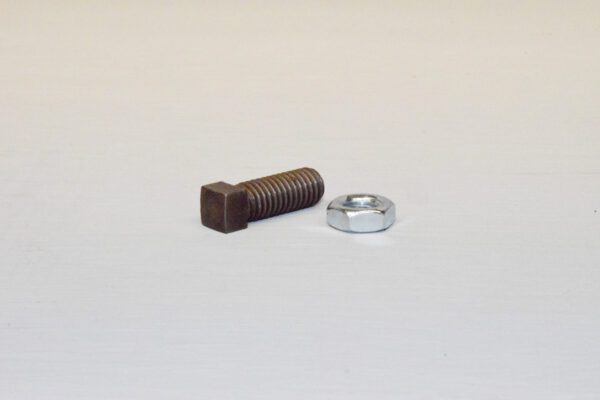 A nut and bolt are next to each other.