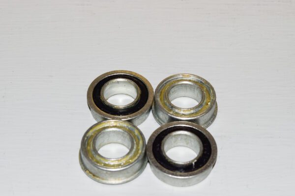 A group of four metal bearings sitting on top of a table.