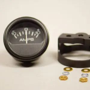 A black and silver meter sitting next to some gold rings