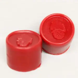 A pair of red caps sitting on top of a table.