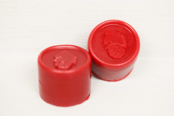 A pair of red caps sitting on top of a table.