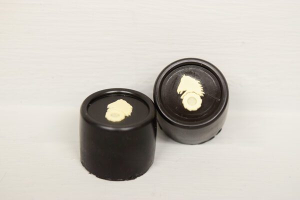 Two black containers with a white horse on the top.