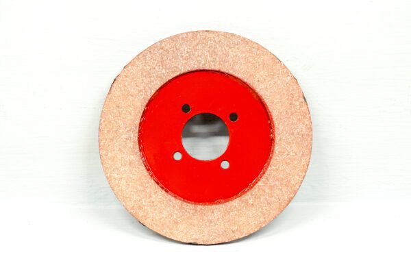 A red disc with a hole in the middle, also known as a Clutch Plate Assembly Wheel Horse.