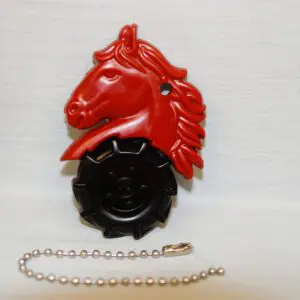A red horse head bottle cap with chain.