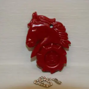 A red horse head with a chain and key.