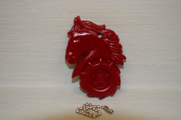 A red horse head with a chain and key.