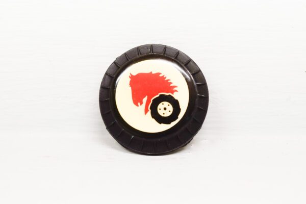 A black and white button with red horse on it.