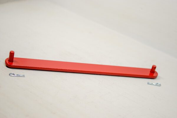 A red strip of plastic on top of a table.
