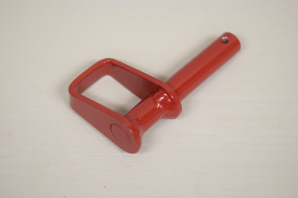 A red handle is sitting on the floor.