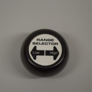 A black knob with the words range selector on it.
