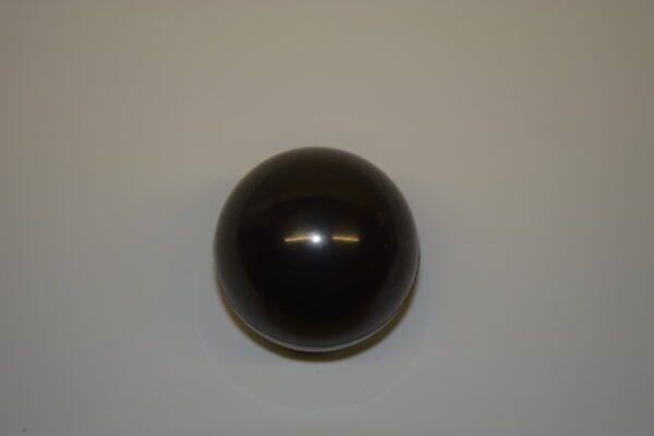 A black ball is on the wall