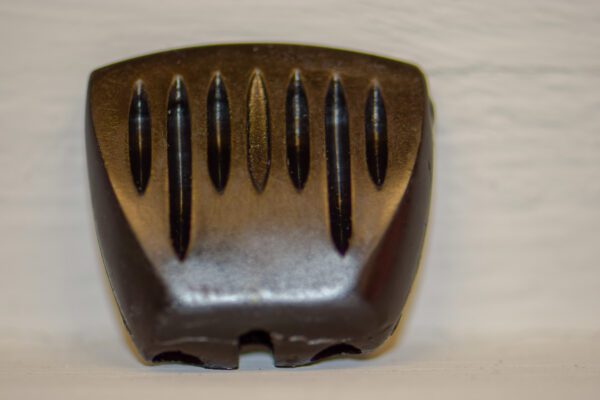 A black comb on a white wall with Throttle / Choke Knob for GT, 300, & 400 Series Wheel Horse.